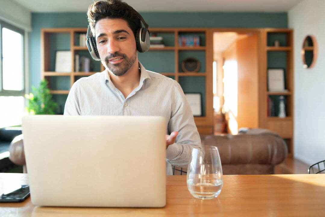 portrait-young-man-work-video-call-with-laptop-from-home-home-office-concept-new-normal-lifestyle 1